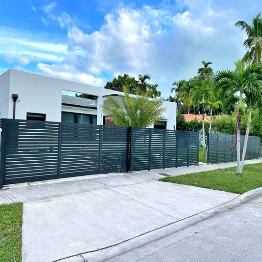 Slat 3" - Horizontal Fence Kit - Gap 1/2" Modern house with a green metal fence and palm trees under a blue sky.